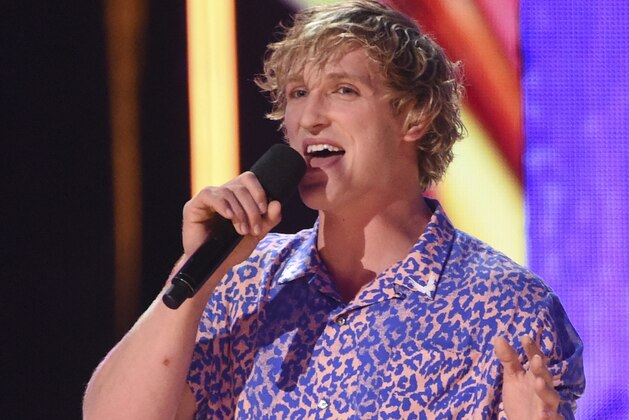 FILE - In this Aug. 13, 2017 file photo, Logan Paul speaks at the Teen Choice Awards at the Galen Center in Los Angeles. YouTube has temporarily suspended all ads from Paul’s channels after what it calls a pattern of behavior unsuitable for advertisers. An email sent to Paul’s merchandise company for comment was not immediately answered Friday, Feb. 9, 2018. (Photo by Phil McCarten/Invision/AP, File)