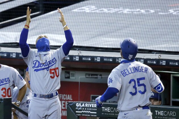 Los Angeles Dodgers' Mookie Betts (50) celebrates a two-run home run by teammate Cody Bellinger (35) against the Arizona Diamondbacks during the first inning of a baseball game Sunday, Aug. 2, 2020, in Phoenix. (AP Photo/Ross D. Franklin)