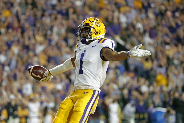 FILE - In this Nov. 30, 2019, file photo, LSU wide receiver Ja'Marr Chase (1) celebrates his touchdown reception during the first half of the team's NCAA college football game against Texas A&M, in Baton Rouge, La. Chase was selected to The Associated Press All-America team, Monday, Dec. 16, 2019.  (AP Photo/Gerald Herbert, File)