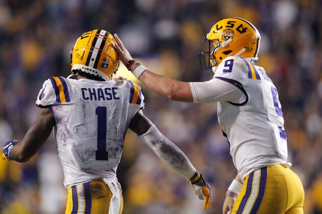 LSU quarterback Joe Burrow (9) celebrates with wide receiver Ja'Marr Chase (1) on their touchdown pass play during the second half of the team's NCAA college football game against Texas A&M in Baton Rouge, La., Saturday, Nov. 30, 2019. LSU won 50-7. (AP Photo/Gerald Herbert)