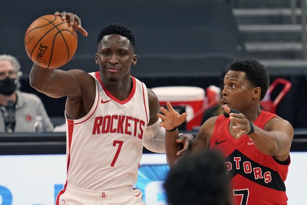 Houston Rockets guard Victor Oladipo (7, left) loses control of the ball in front of Toronto Raptors guard Kyle Lowry during the first half of an NBA basketball game Friday, Feb. 26, 2021, in Tampa, Fla. (AP Photo/Chris O'Meara)
