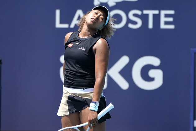 Naomi Osaka, of Japan, reacts during her match against Maria Sakkari, of Greece, in the quarterfinals of the Miami Open tennis tournament, Wednesday, March 31, 2021, in Miami Gardens, Fla. Sakkari won 6-0, 6-4. (AP Photo/Lynne Sladky)