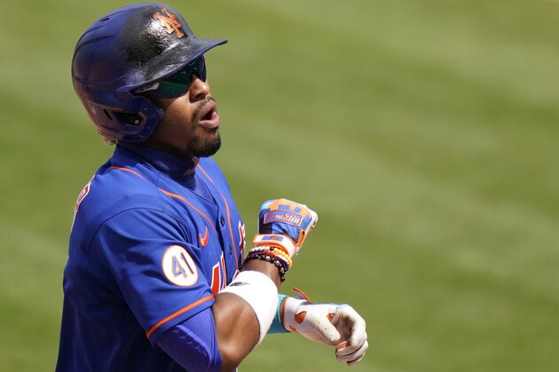 New York Mets' Francisco Lindor (12) reacts after scoring god a solo home run during the fifth inning of a spring training baseball game against the Miami Marlins, Tuesday, March 23, 2021, in Port St. Lucie, Fla. (AP Photo/Lynne Sladky)