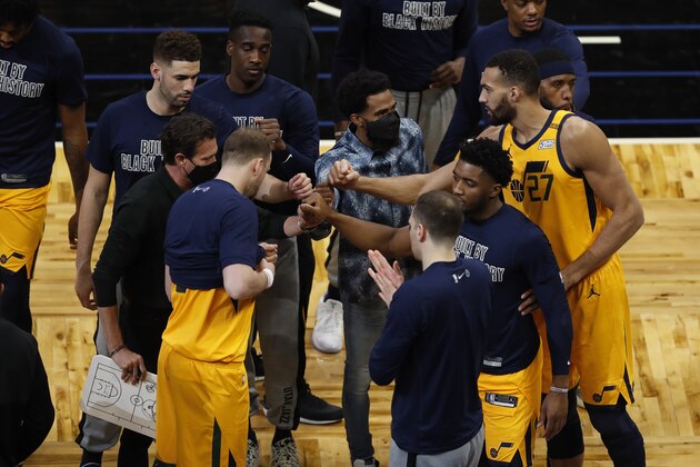 Utah Jazz players huddle before play against the Orlando Magic during an NBA basketball game, Saturday Feb. 27, 2021, in Orlando, Fla. (AP Photo/Joe Skipper)