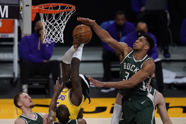 Milwaukee Bucks forward Giannis Antetokounmpo (34) blocks a shot by Los Angeles Lakers center Montrezl Harrell (15) during the third quarter of an NBA basketball game Wednesday, March 31, 2021, in Los Angeles. (AP Photo/Ashley Landis)
