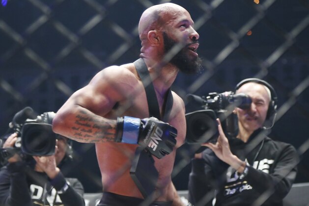 Mixed martial arts (MMA) fighters Demetrious Johnson of the United States celebrates after defeating Japan's Yuya Wakamatsu during their flyweight world grand prix quarterfinal of One Championship bout in Tokyo, Sunday, March 31, 2019. (AP Photo/Koji Sasahara)