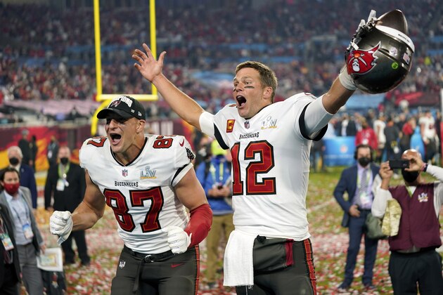 FILE - In this Sunday, Feb. 7, 2021 file photo, Tampa Bay Buccaneers tight end Rob Gronkowski (87), left, and Tampa Bay Buccaneers quarterback Tom Brady (12) celebrate together after the NFL Super Bowl 55 football game against the Kansas City Chiefs in Tampa, Fla. NFL Films has been chronicling Tom Brady’s career since he entered the league in 2000, but there are still times when there are still new things to reveal. That is the case with this year’s Super Bowl film, chronicling Brady’s seventh championship and his first with the Tampa Buccaneers.  (AP Photo/Steve Luciano, File)