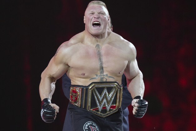 FILE - In this March 29, 2015, file photo, Brock Lesnar makes his entrance at Wrestlemania XXXI in Santa Clara, Calif. While real sports have shut down in the wake of the coronavirus pandemic, WWE has pressed on and is set to run this weekend its first WrestleMania in an empty arena. WWE stood firm that the show must go on and largely moved a card highlighted by stars Brock Lesnar and John Cena to its performance center in Orlando, Florida. (AP Photo/Don Feria, File)