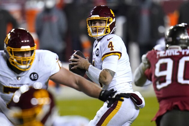 Washington Football Team quarterback Taylor Heinicke (4) looks to pass against the Tampa Bay Buccaneers during the second half of an NFL wild-card playoff football game, Saturday, Jan. 9, 2021, in Landover, Md. Tampa Bay won 31-23. (AP Photo/Julio Cortez)