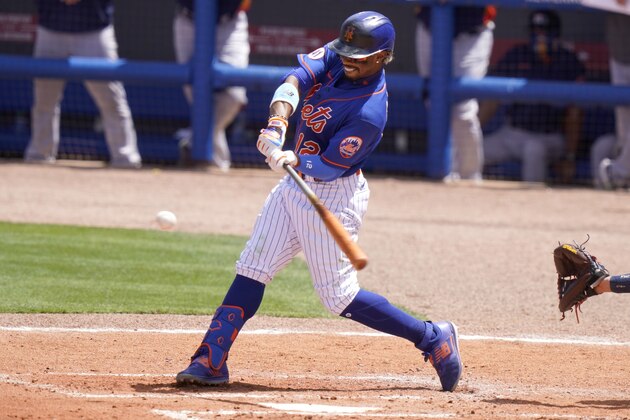 New York Mets' Francisco Lindor hits a RBI single to score two runs during the third inning of a spring training baseball game against the Houston Astros, Saturday, March 27, 2021, in Port St. Lucie, Fla. (AP Photo/Lynne Sladky)
