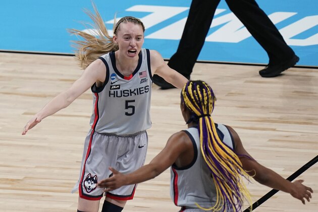 UConn guard Paige Bueckers (5) celebrates a score with teammate Aaliyah Edwards against Baylor during the first half of a college basketball game in the Elite Eight round of the women's NCAA tournament at the Alamodome in San Antonio, Monday, March 29, 2021. (AP Photo/Eric Gay)
