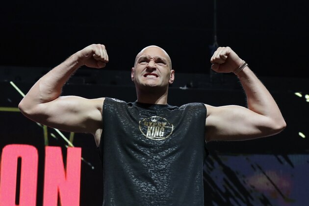 FILE - In this Feb. 21, 2020, file photo, Tyson Fury, of England, stands on the scale during a weigh-in for his WBC heavyweight championship boxing match against Deontay Wilder, in Las Vegas. An all-British world heavyweight title showdown between Anthony Joshua and Tyson Fury in 2021 is a step closer. Fury said Wednesday, June 10, 2020, that an agreement has been reached with Joshua's camp on a two-fight deal between the current holders of the heavyweight belts.(AP Photo/Isaac Brekken, File)