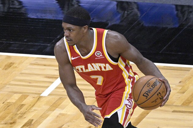 Atlanta Hawks guard Rajon Rondo (7) sets up a play during the second half of an NBA basketball game against the Orlando Magic, Wednesday, March 3, 2021, in Orlando, Fla. (AP Photo/Phelan M. Ebenhack)
