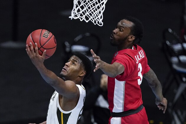 Baylor guard Jared Butler, left, drives to the basket ahead of Houston guard DeJon Jarreau (3) during the first half of a men's Final Four NCAA college basketball tournament semifinal game, Saturday, April 3, 2021, at Lucas Oil Stadium in Indianapolis. (AP Photo/Darron Cummings)