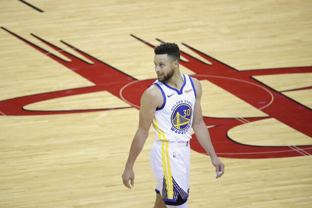 Golden State Warriors' Stephen Curry smiles while looking back during the third quarter against the Houston Rockets in an NBA basketball game Wednesday, March 17, 2021, in Houston. (Carmen Mandato/Pool Photo via AP)
