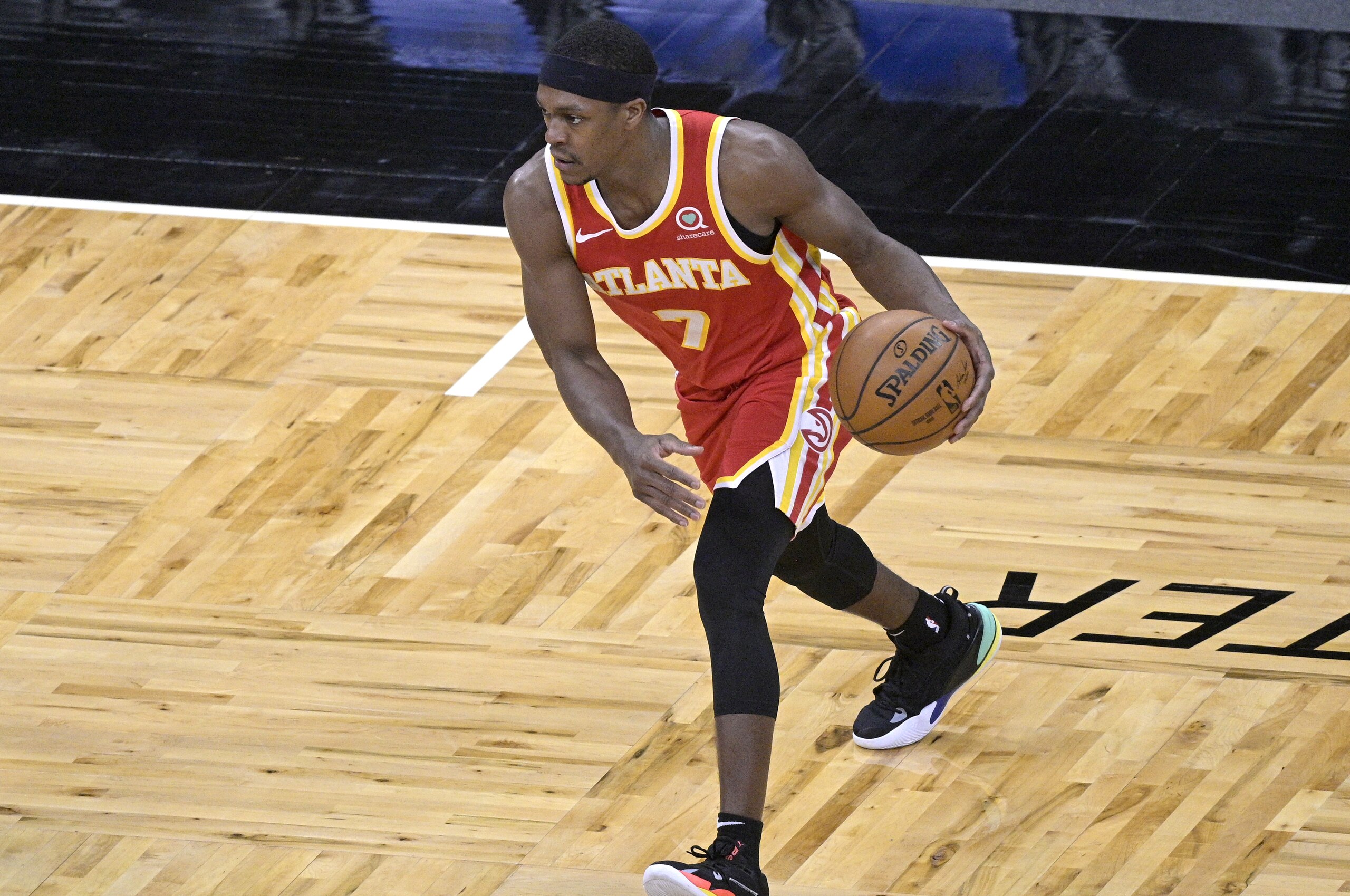 Atlanta Hawks guard Rajon Rondo (7) sets up a play during the second half of an NBA basketball game against the Orlando Magic, Wednesday, March 3, 2021, in Orlando, Fla. (AP Photo/Phelan M. Ebenhack)