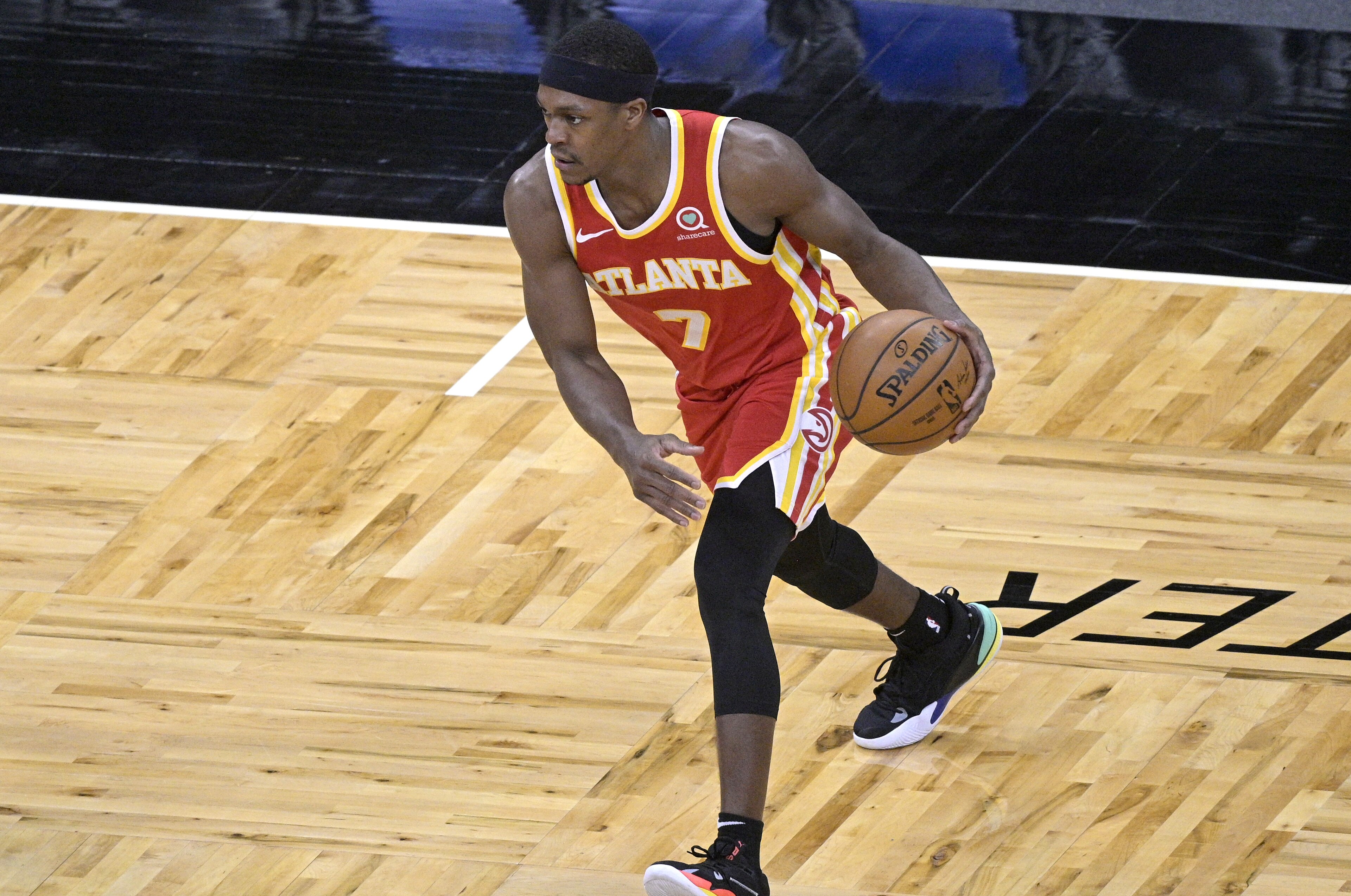 Atlanta Hawks guard Rajon Rondo (7) sets up a play during the second half of an NBA basketball game against the Orlando Magic, Wednesday, March 3, 2021, in Orlando, Fla. (AP Photo/Phelan M. Ebenhack)