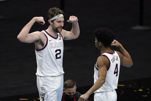 Gonzaga forward Drew Timme (2) celebrates with teammate guard Aaron Cook (4) after making a basket during the second half of a men's Final Four NCAA college basketball tournament semifinal game against UCLA, Saturday, April 3, 2021, at Lucas Oil Stadium in Indianapolis. (AP Photo/Darron Cummings)
