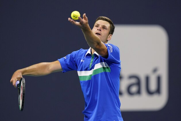 Hubert Hurkacz, of Poland, tosses the ball for a serve to Andrey Rublev, of Russia, during the Miami Open tennis tournament Friday, April 2, 2021, in Miami Gardens, Fla. (AP Photo/Wilfredo Lee)