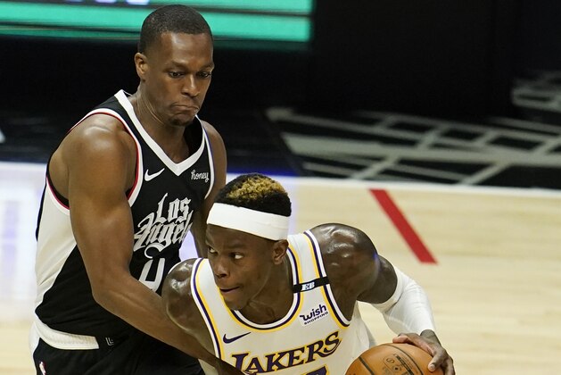 Los Angeles Lakers guard Dennis Schroder (17) is defended by Los Angeles Clippers guard Rajon Rondo during the second half of an NBA basketball game Sunday, April 4, 2021, in Los Angeles. (AP Photo/Marcio Jose Sanchez)