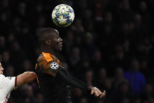 Valencia's Mouctar Diakhaby, right, clears with a header before Ajax's Klaas-Jan Huntelaar, left, during the group H Champions League soccer match between Ajax and Valencia at the Johan Cruyff ArenA in Amsterdam, Netherlands, Tuesday, Dec. 10, 2019. (AP Photo/Peter Dejong)