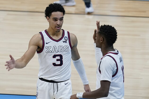Gonzaga guard Joel Ayayi, right, celebrates with teammate guard Andrew Nembhard (3) after making a basket during the first half of a men's Final Four NCAA college basketball tournament semifinal game against UCLA, Saturday, April 3, 2021, at Lucas Oil Stadium in Indianapolis. (AP Photo/Darron Cummings)