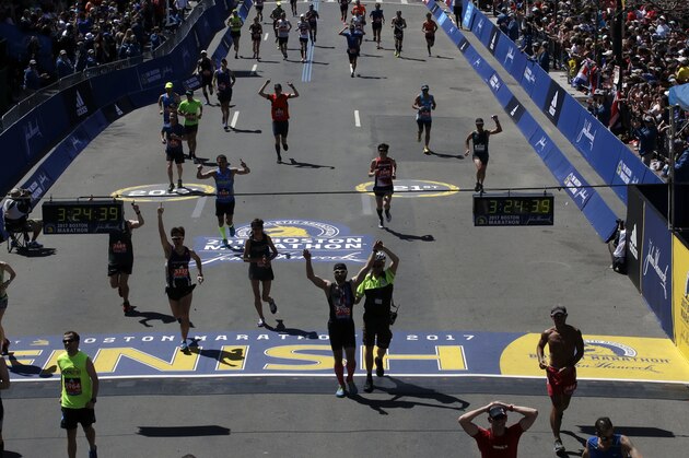 Runners cros the finish line in the 121st Boston Marathon on Monday, April 17, 2017, in Boston. (AP Photo/Charles Krupa)