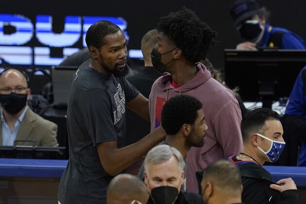 Brooklyn Nets forward Kevin Durant, left, greets injured Golden State Warriors center James Wiseman during an NBA basketball game in San Francisco, Saturday, Feb. 13, 2021. (AP Photo/Jeff Chiu)