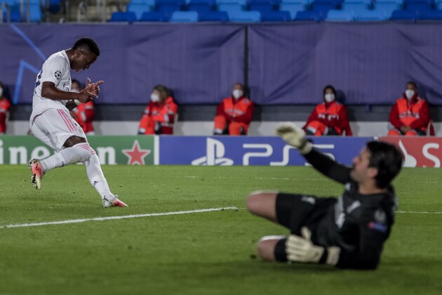Real Madrid's Vinicius Junior, left, celebrates after scoring his second goal during the Champions League quarterfinal first leg, soccer match between Real Madrid and Liverpool at the Alfredo di Stefano stadium in Madrid, Spain, Tuesday, April 6, 2021. (AP Photo/Manu Fernandez)