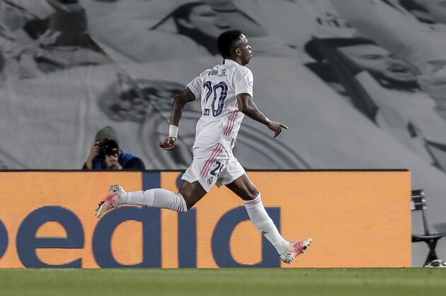 Real Madrid's Vinicius Junior celebrates after scoring the opening goal during the Champions League quarterfinal first leg, soccer match between Real Madrid and Liverpool at the Alfredo di Stefano stadium in Madrid, Spain, Tuesday, April 6, 2021. (AP Photo/Manu Fernandez)