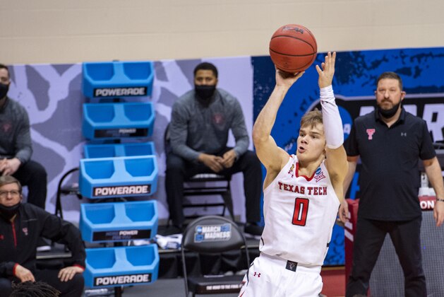 Texas Tech guard Mac McClung (0) shoots a three-point shot during the second half of a first round game against Utah State in the NCAA men's college basketball tournament, Friday, March 19, 2021, at Assembly Hall in Bloomington, Ind. (AP Photo/Doug McSchooler)