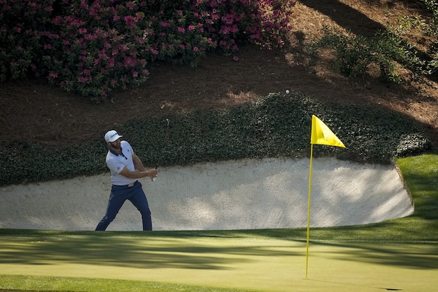 Dustin Johnson hits from the bunker on the 12th hole during a practice round for the Masters golf tournament on Tuesday, April 6, 2021, in Augusta, Ga. (AP Photo/Charlie Riedel)