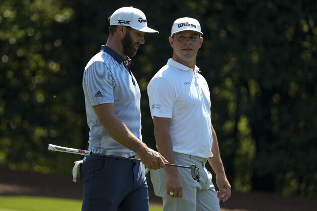 Dustin Johnson and Gary Woodland walk on the 11th hole during a practice round for the Masters golf tournament on Tuesday, April 6, 2021, in Augusta, Ga. (AP Photo/Charlie Riedel)
