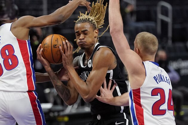 Brooklyn Nets forward Nicolas Claxton grabs the rebound next to Detroit Pistons center Mason Plumlee (24) during the first half of an NBA basketball game, Friday, March 26, 2021, in Detroit. (AP Photo/Carlos Osorio)