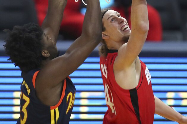 Houston Rockets center Kelly Olynyk, right, shoots next to Golden State Warriors center James Wiseman during the first half of an NBA basketball game in San Francisco, Saturday, April 10, 2021. (AP Photo/Jed Jacobsohn)