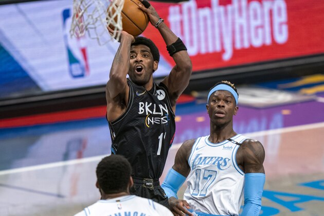 Brooklyn Nets guard Kyrie Irving shoots over Los Angeles Lakers center Andre Drummond and guard Dennis Schroeder (17) during the first half of an NBA basketball game, Saturday, April 10, 2021, in New York (AP Photo/Corey Sipkin).