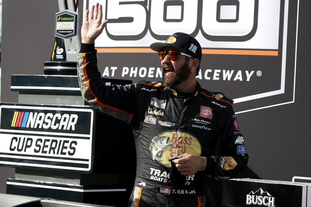 Martin Truex Jr waves to fans from Victory Lane after winning a NASCAR Cup Series auto race at Phoenix Raceway, Sunday, March 14, 2021, in Avondale, Ariz. (AP Photo/Ralph Freso)
