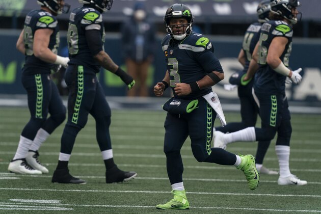 Seattle Seahawks quarterback Russell Wilson jogs off the field during the first half of an NFL wild-card playoff football game against the Los Angeles Rams, Saturday, Jan. 9, 2021, in Seattle. The Rams won 30-20. (AP Photo/Stephen Brashear)