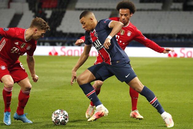 Bayern's Joshua Kimmich, left, Bayern's Leroy Sane, right, and PSG's Kylian Mbappe challenge for the ball during the Champions League, second leg, quarterfinal soccer match between Paris Saint Germain and Bayern Munich at the Parc des Princes stadium, in Paris, France, Tuesday, April 13, 2021. (AP Photo/Francois Mori)
