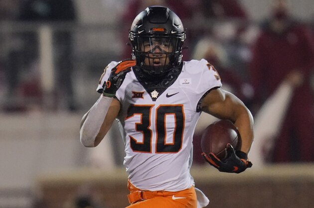 Oklahoma State running back Chuba Hubbard (30) carries during an NCAA college football game against Oklahoma in Norman, Okla., Saturday, Nov. 21, 2020. (AP Photo/Sue Ogrocki)