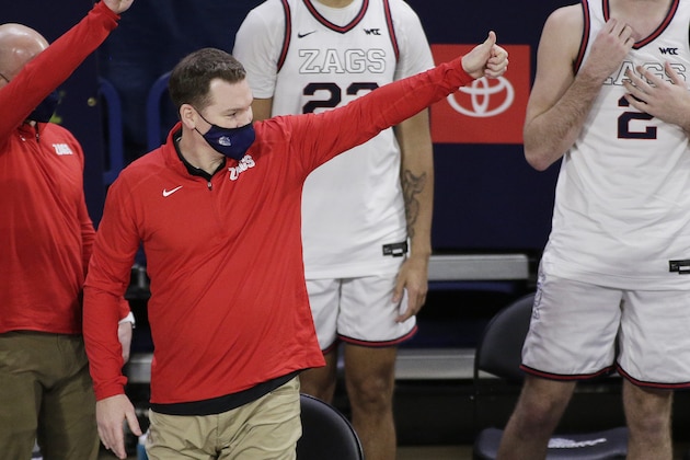 Gonzaga assistant coach Tommy Lloyd gestures to Northern Arizona players, coaches and staff after an NCAA college basketball game in Spokane, Wash., Monday, Dec. 28, 2020. (AP Photo/Young Kwak)
