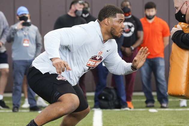 Christian Darrisaw runs a drill Virginia Tech pro day, attended by NFL football scouts, in Blacksburg, Va., Friday, March 26, 2021. (AP Photo/Matt Gentry)