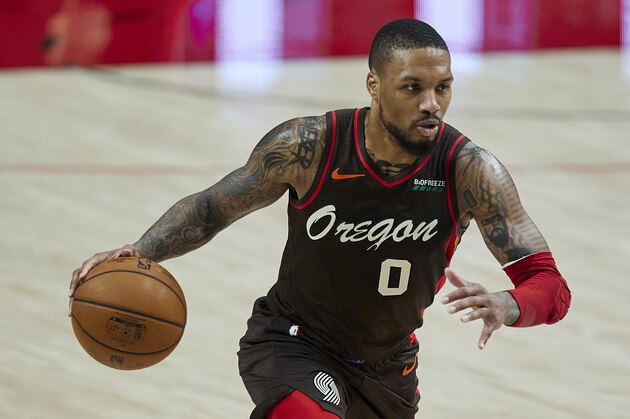 Portland Trail Blazers guard Damian Lillard brings the ball up court against the Golden State Warriors during the first half of an NBA basketball game in Portland, Ore., Wednesday, March 3, 2021. (AP Photo/Craig Mitchelldyer)