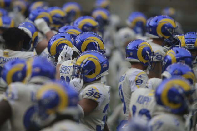 Los Angeles Rams players put on their helmets before an NFL football game against the Seattle Seahawks, Sunday, Dec. 27, 2020, in Seattle. (AP Photo/Scott Eklund)