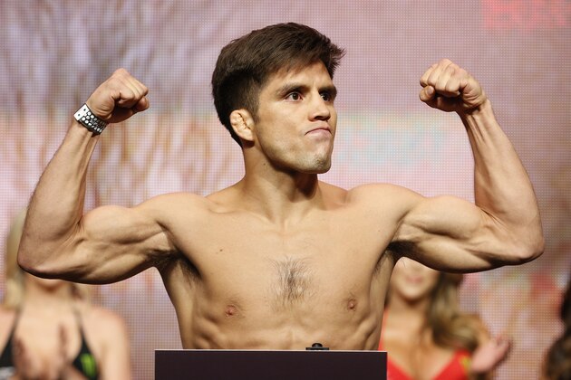 Henry Cejudo poses on the scale during a weigh-in for UFC 197, Friday, April 22, 2016, in Las Vegas. Cejudo is scheduled to fight Demetrious Johnson in a flyweight title bout Saturday in Las Vegas. (AP Photo/John Locher)