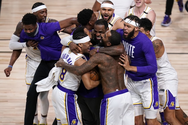 The Los Angeles Lakers players celebrate after the Lakers defeated the Miami Heat 106-93 in Game 6 of basketball's NBA Finals Sunday, Oct. 11, 2020, in Lake Buena Vista, Fla. (AP Photo/John Raoux)