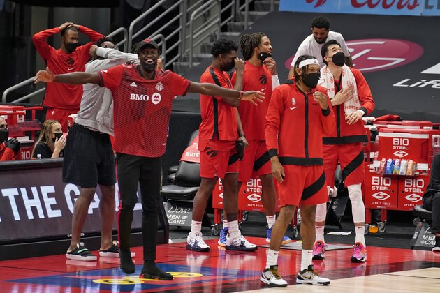 Toronto Raptors' Pascal Siakam, left, celebrates a three-point basket by Paul Watson Jr. during the second half of an NBA basketball game against the Orlando Magic Friday, April 16, 2021, in Tampa, Fla. (AP Photo/Chris O'Meara)
