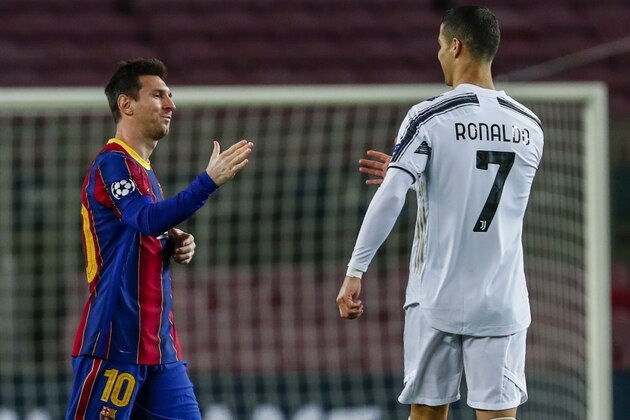 Barcelona's Lionel Messi, left, shakes has with Juventus' Cristiano Ronaldo prior of the start of the Champions League group G soccer match between FC Barcelona and Juventus at the Camp Nou stadium in Barcelona, Spain, Tuesday, Dec. 8, 2020. (AP Photo/Joan Monfort)