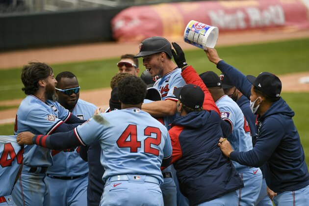 Minnesota Twins' Max Kepler, center with helmet, celebrates with his team after driving in the winning run in the ninth inning of a baseball game against the Boston Red Sox, Thursday, April 15, 2021, in Minneapolis. The Twins won 4-3. (AP Photo/Craig Lassig)