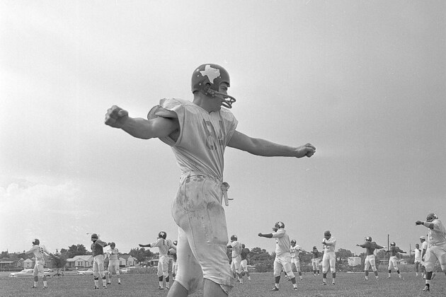 Led by end Fred Arbanas, members of the Dallas Texans rookie squad do calisthenics as workouts get under way in Dallas, Texas, July 18, 1962. Arbanas, the Michigan State player is listed as a rookie for the second year because of a 1961 injury. (AP Photo)